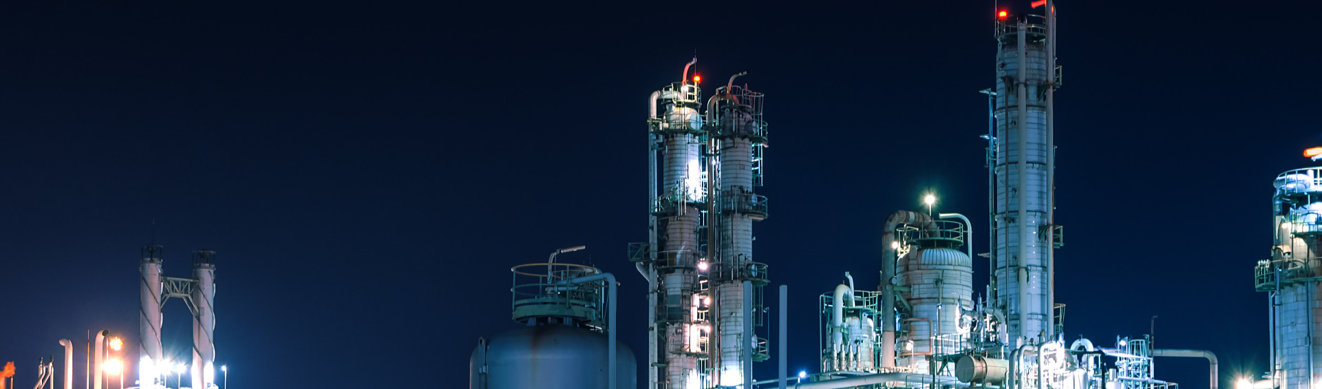 A Microwatt serviced oil and gas plant at night.